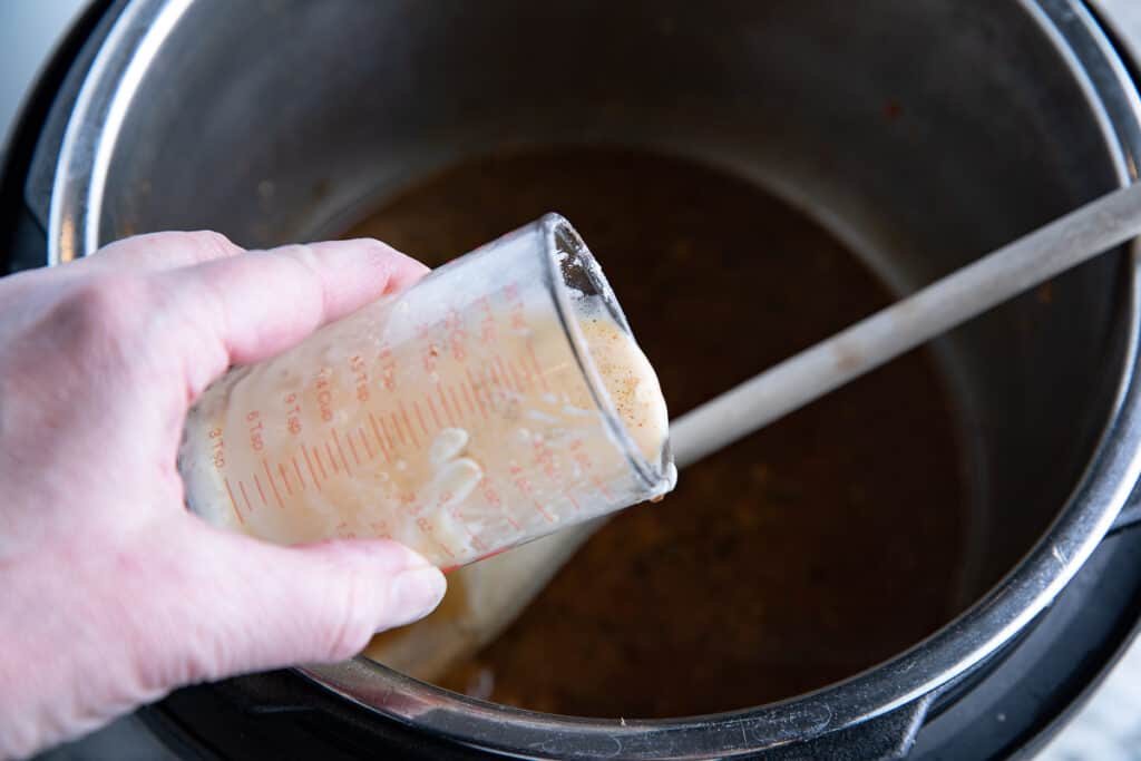cornstarch slurry being poured into Instant Pot