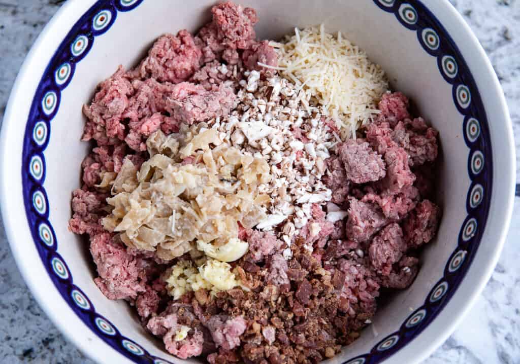 ground beef,cheese, spices, onions in a large bowl