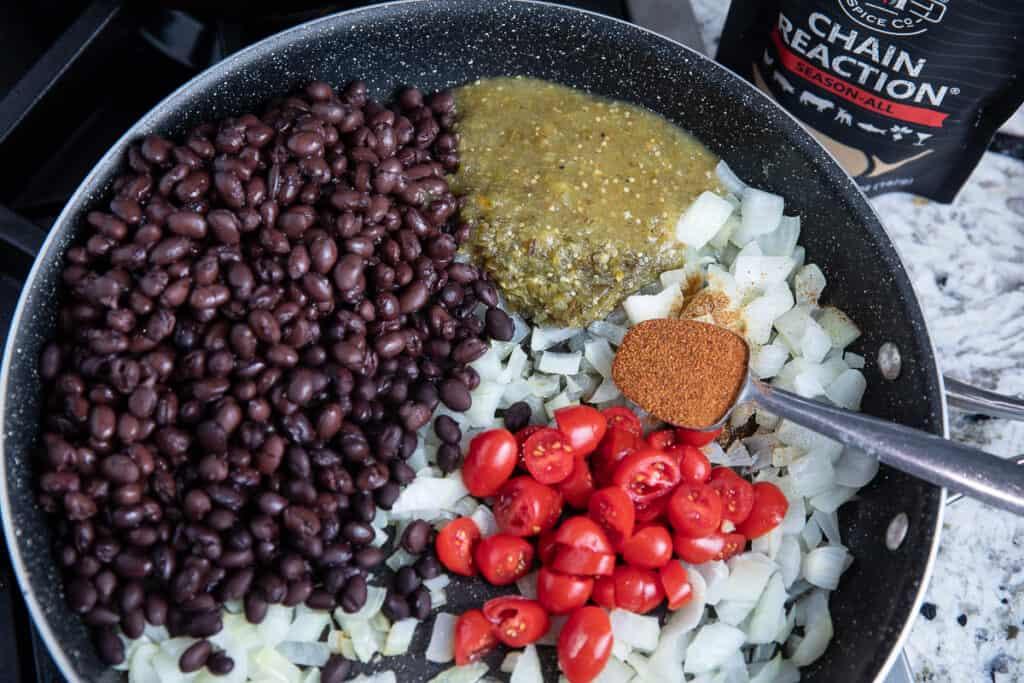 skillet with black beans, tomatoes, onions, salsa, Chain Reaction spice