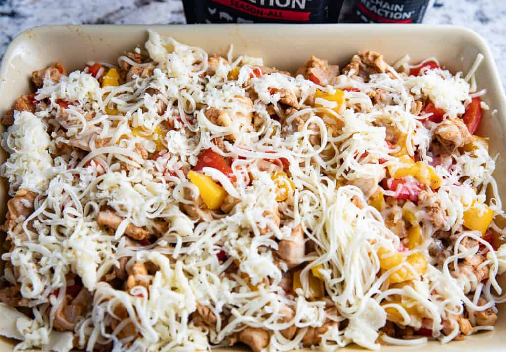 casserole dish with cheese, peppers, chicken