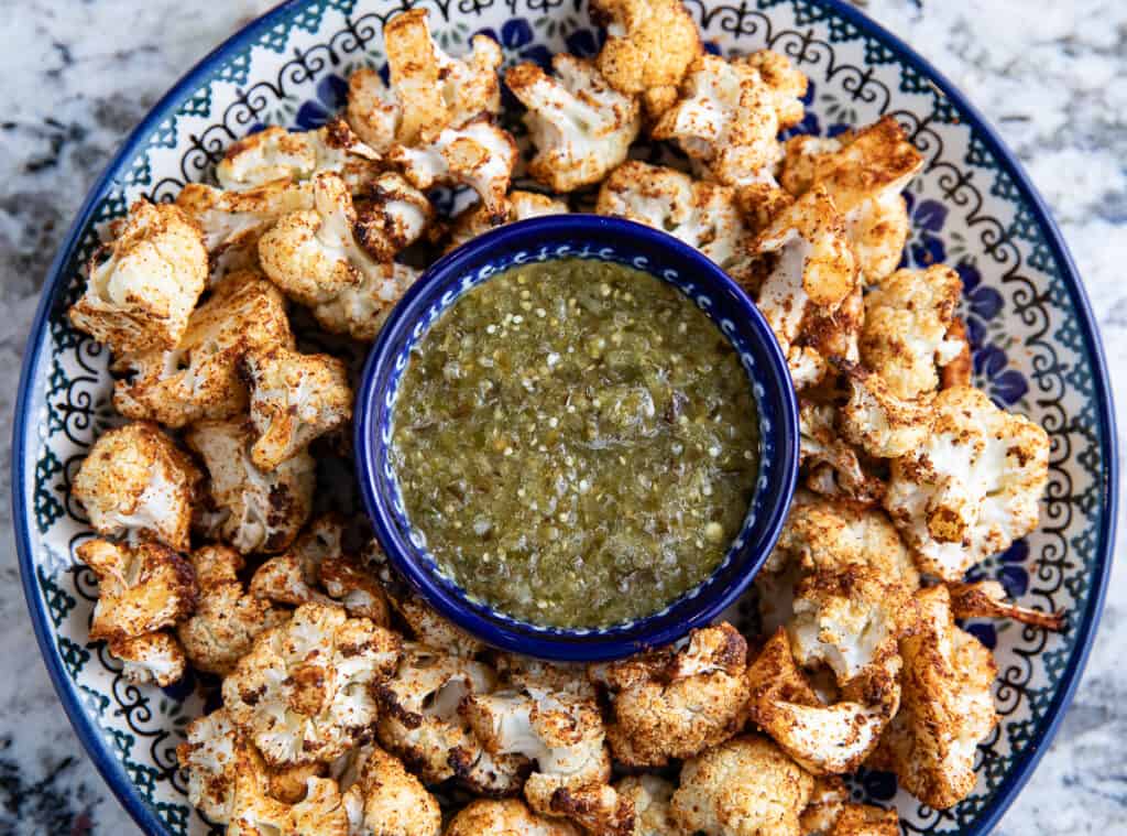air fried cauliflower on a plate with roasted tomatillo salsa