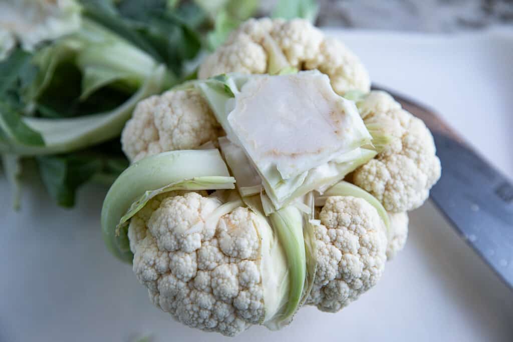 raw cauliflower being trimmed