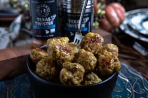 meatballs in a black bowl with spices in the background