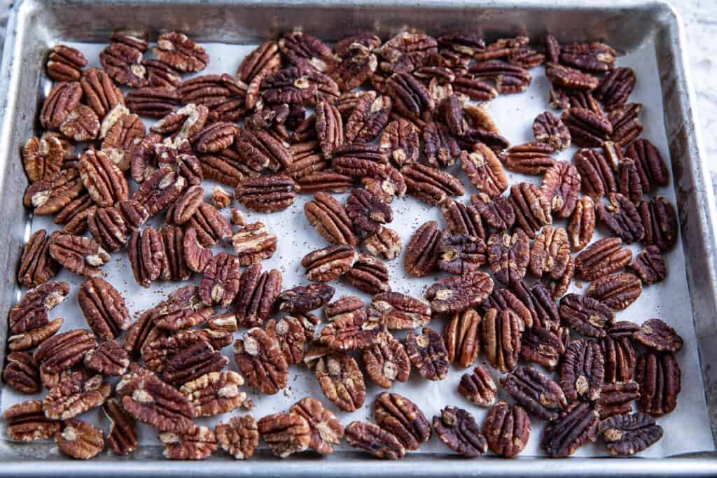 roasted pecans on a baking sheet