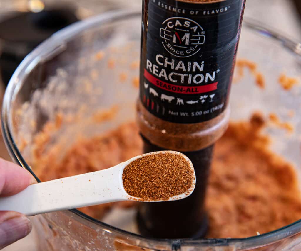 Casa M Chain Reaction spice in a teaspoon with spice and food processor in background
