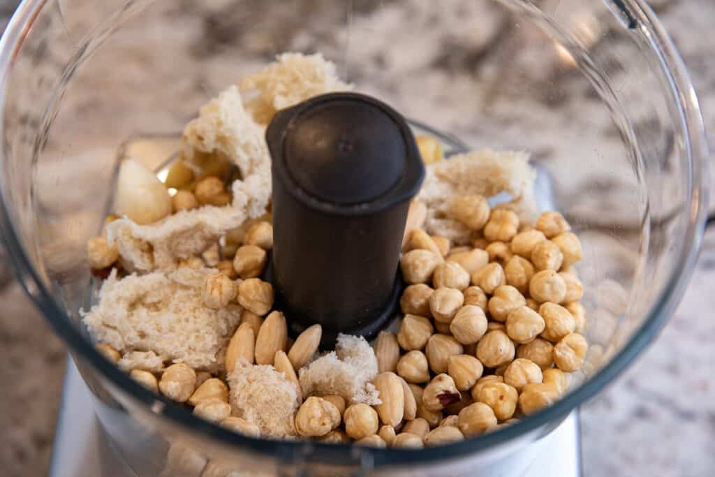 almonds and hazelnuts and bread in a food processor